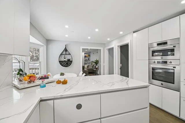a living room with furniture a fireplace and a potted plant