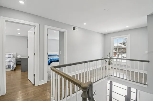 a large bedroom with a bed and glass table