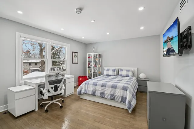 a bedroom with a bed and a window