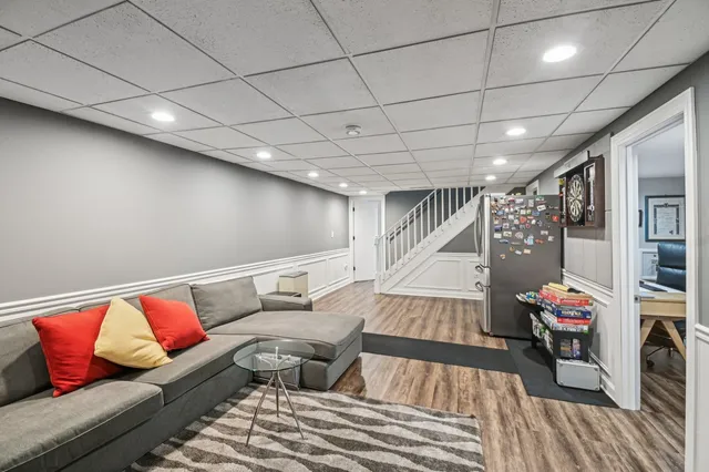 a living room with furniture and a book shelf