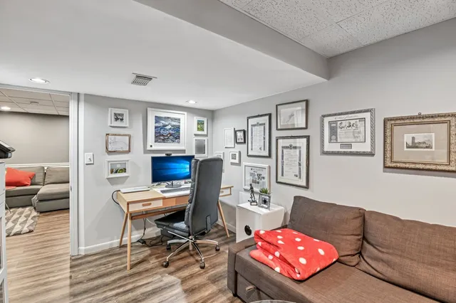 a dining room with furniture and wooden floor
