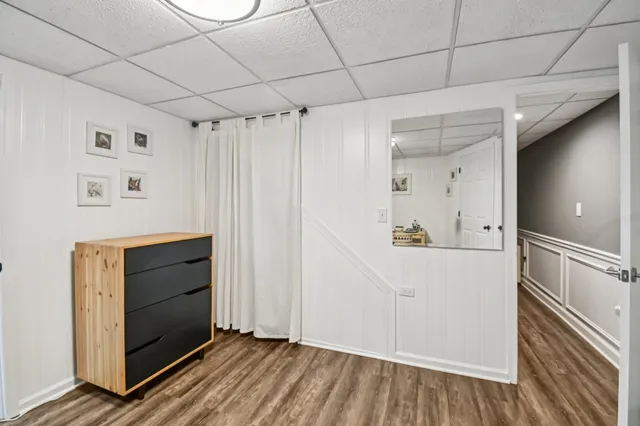 a view of a hallway with wooden floor and windows