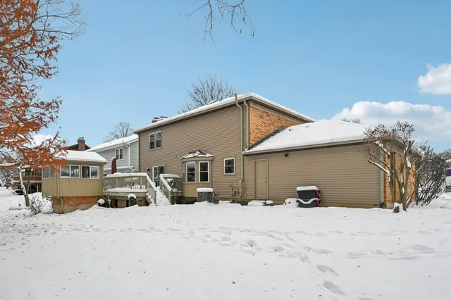 a view of a house with snow on the road