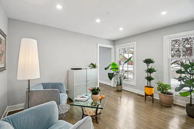 a living room with furniture potted plant and a window