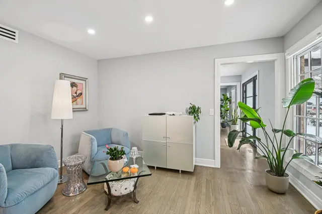 a view of entryway and hall with wooden floor
