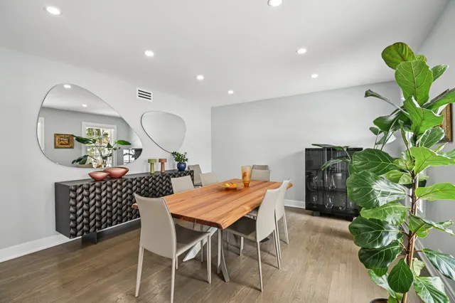 a large white kitchen with stainless steel appliances granite countertop a refrigerator and a sink
