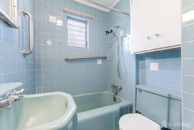 a white bath tub sitting next to a toilet