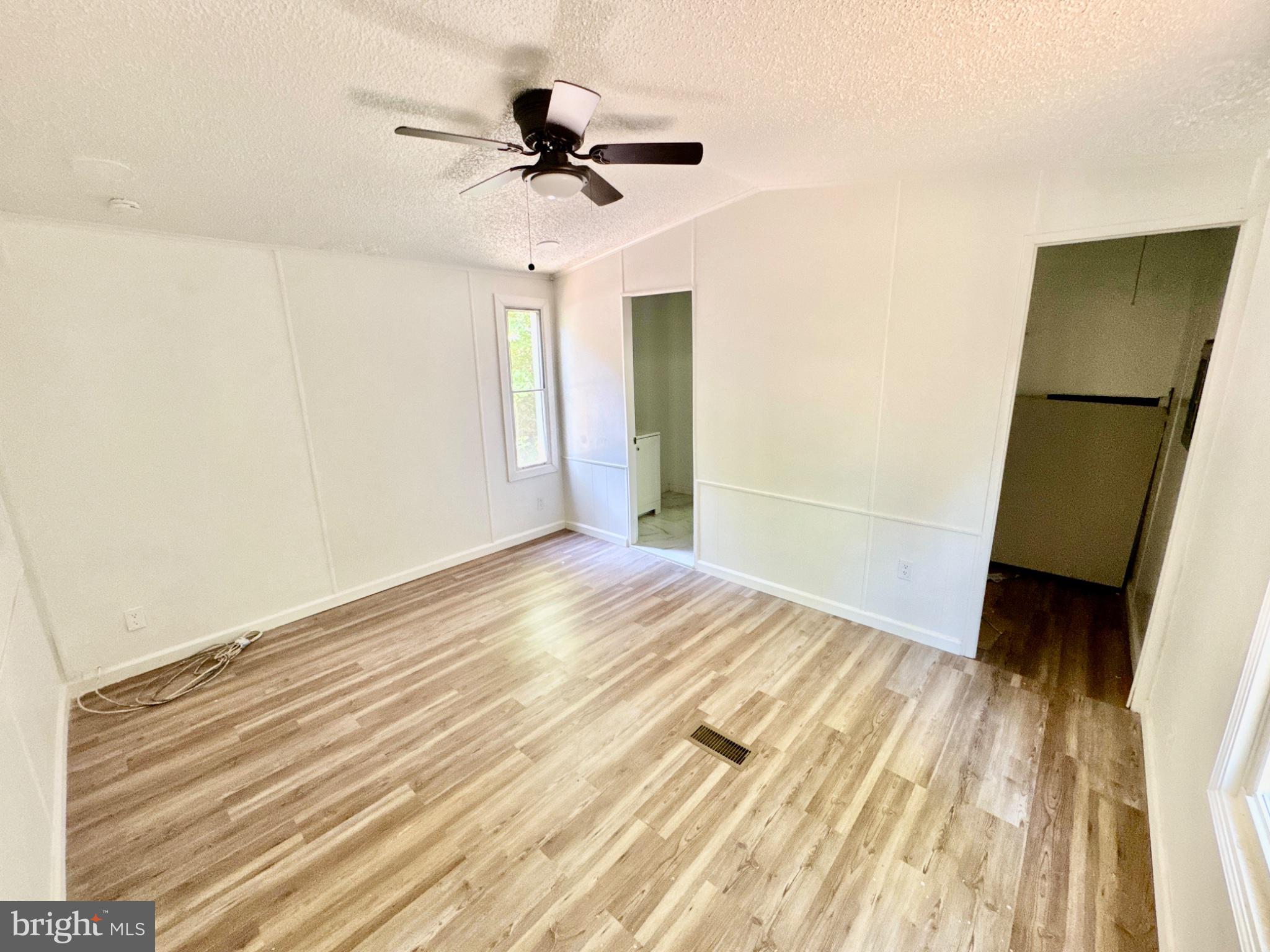 448 Evergreen Road Millville, NJ 08332 - Photo 21 of 25 a view of a room with wooden floor and a ceiling fan