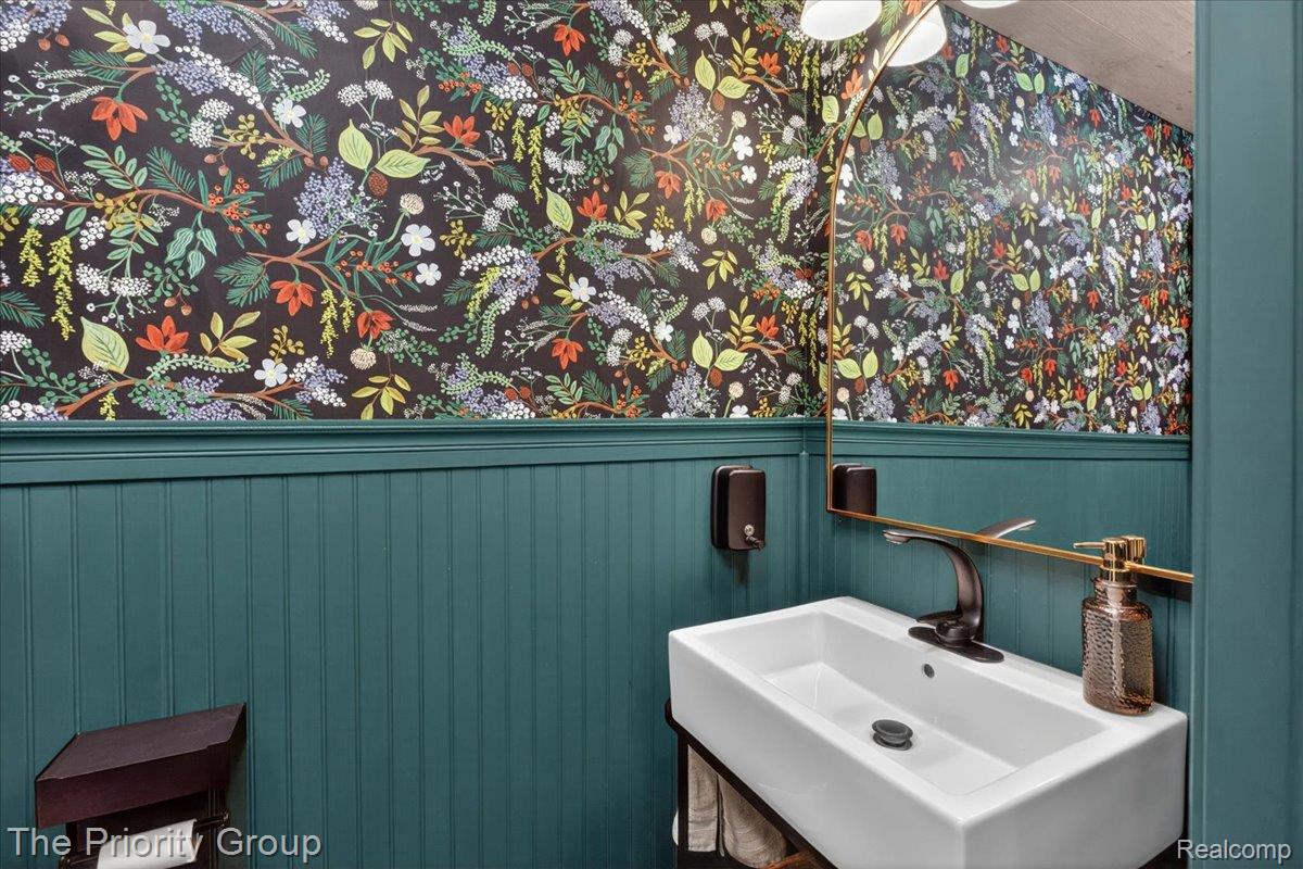 517 Deer Valley Road Holly, MI 48442 - Photo 29 of 61 Half bath near laundry off kitchen, with funky wallpaper and wainscoting