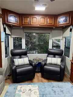 a living room with furniture and a chair