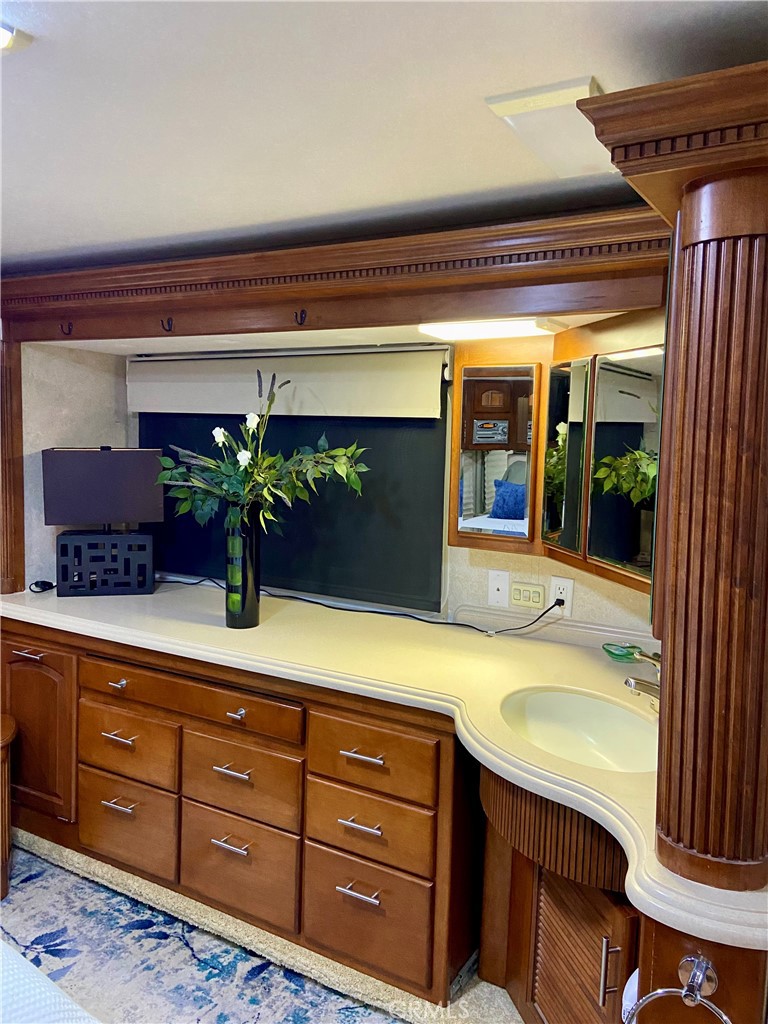 69411 Ramon Road Cathedral City, CA 92234 - Photo 9 of 14 a bathroom with a granite countertop sink and a mirror
