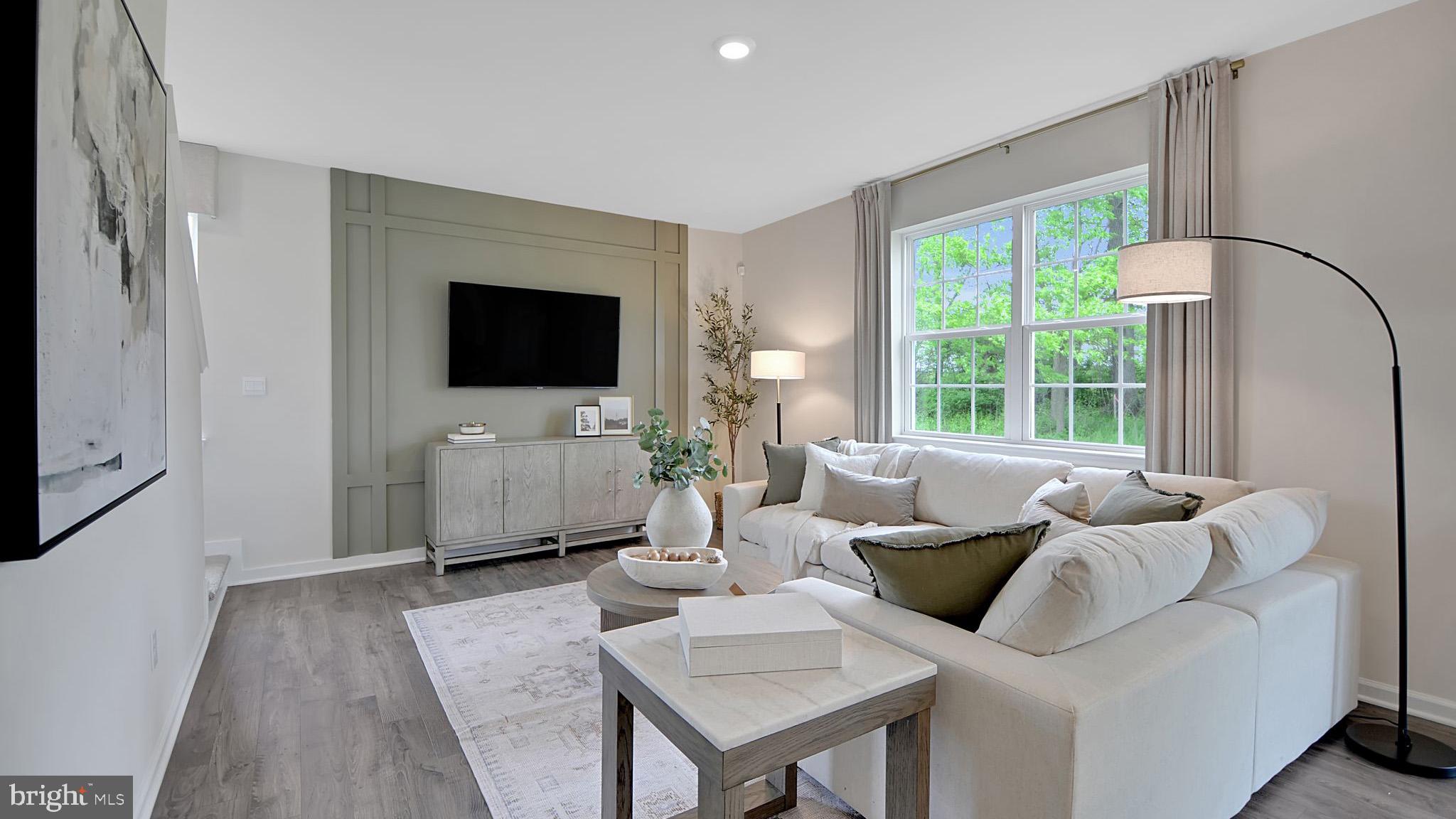 12 Cudesa Court Hanover, PA 17331 - Photo 10 of 25 a living room with furniture a flat screen tv and a large window