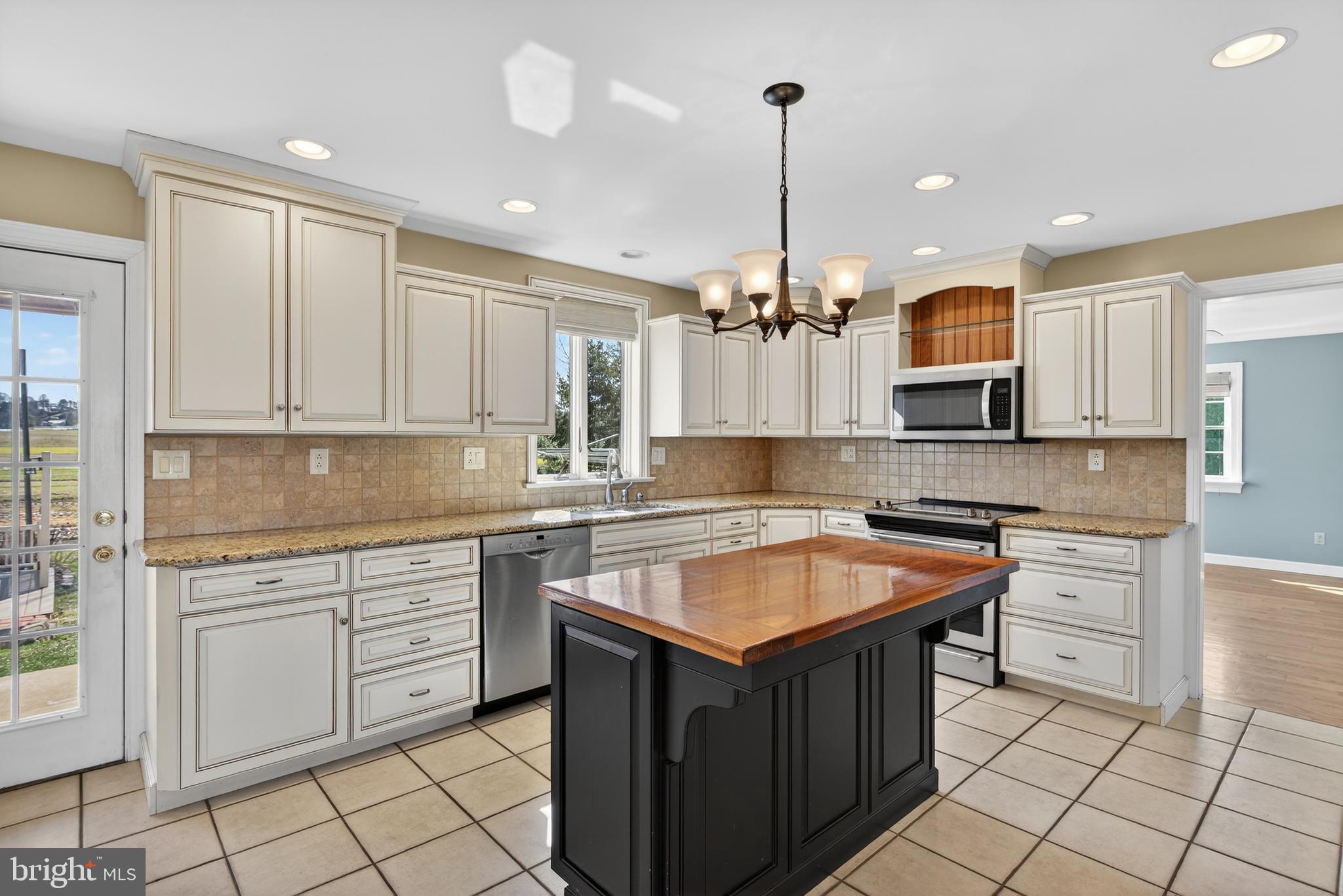 414 Twin Elm Road Strasburg, PA 17579 - Photo 11 of 30 a kitchen with kitchen island granite countertop a sink counter top space appliances and cabinets