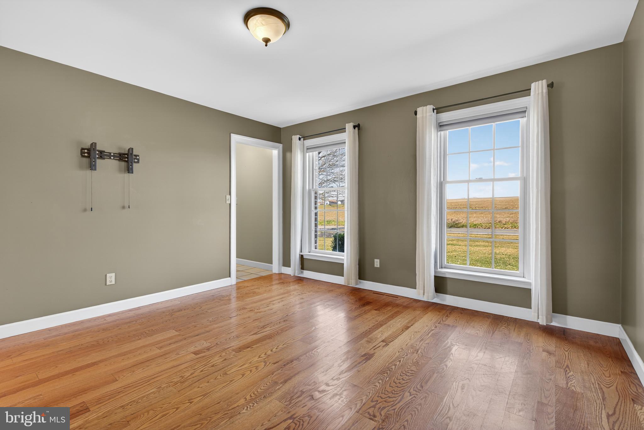 414 Twin Elm Road Strasburg, PA 17579 - Photo 16 of 30 an empty room with wooden floor and windows