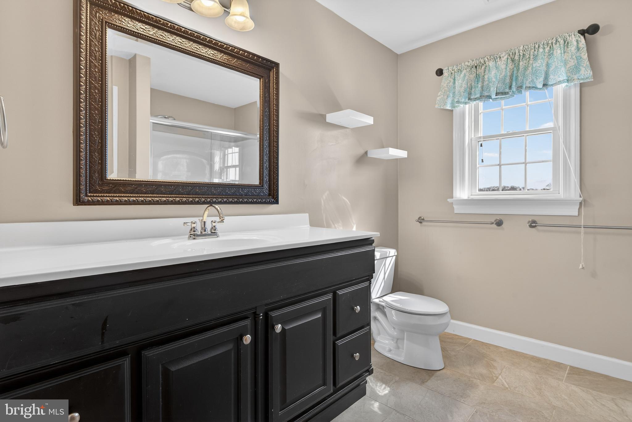 414 Twin Elm Road Strasburg, PA 17579 - Photo 23 of 30 a bathroom with a toilet a sink a vanity and mirror