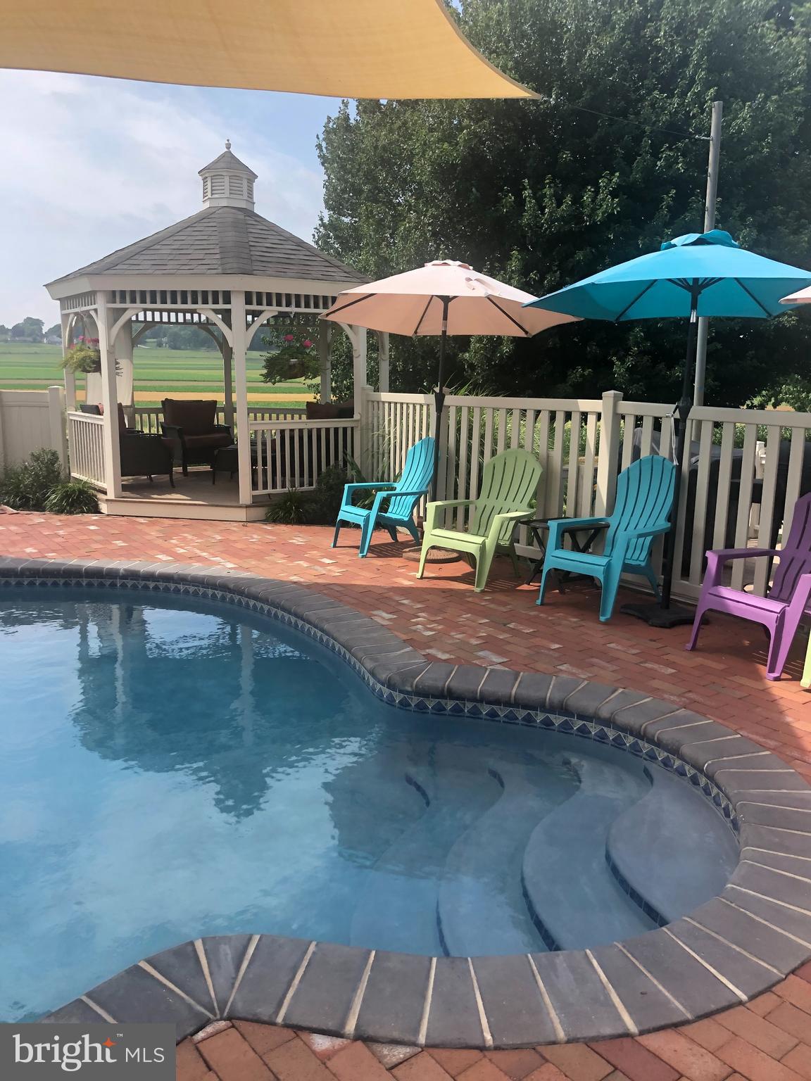 414 Twin Elm Road Strasburg, PA 17579 - Photo 6 of 30 a view of a patio with a table and chairs under an umbrella