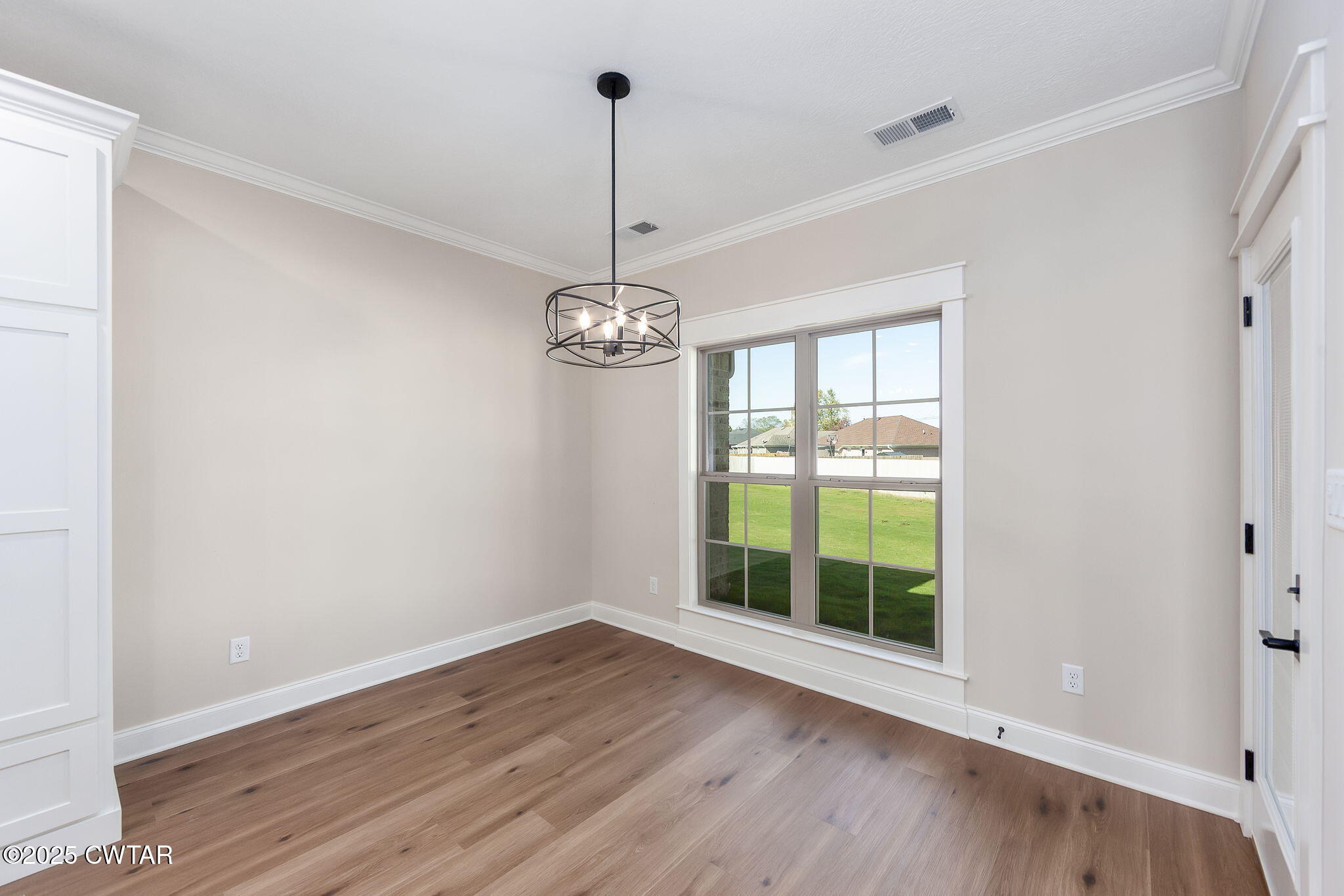 24 Enoch Cove Jackson, TN 38305 - Photo 13 of 30 a view of an empty room with wooden floor and a window
