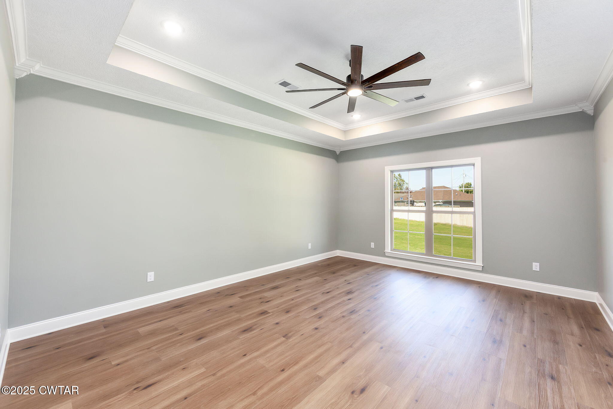 24 Enoch Cove Jackson, TN 38305 - Photo 14 of 30 a view of an empty room with a window and wooden floor
