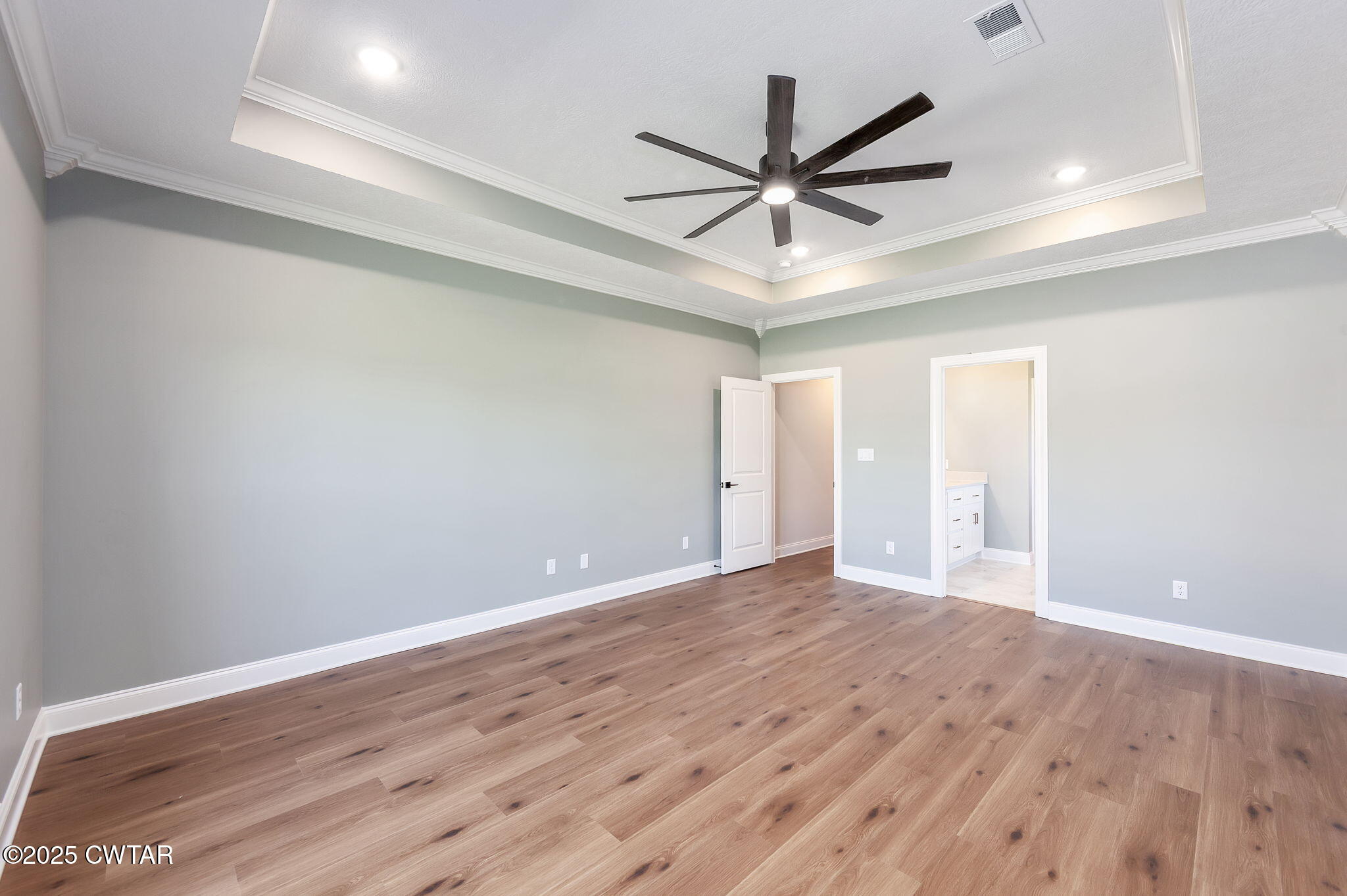 24 Enoch Cove Jackson, TN 38305 - Photo 15 of 30 a view of a big room with wooden floor a ceiling fan and windows