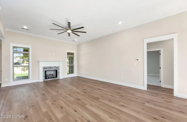 a view of a livingroom with a hardwood floor and a ceiling fan