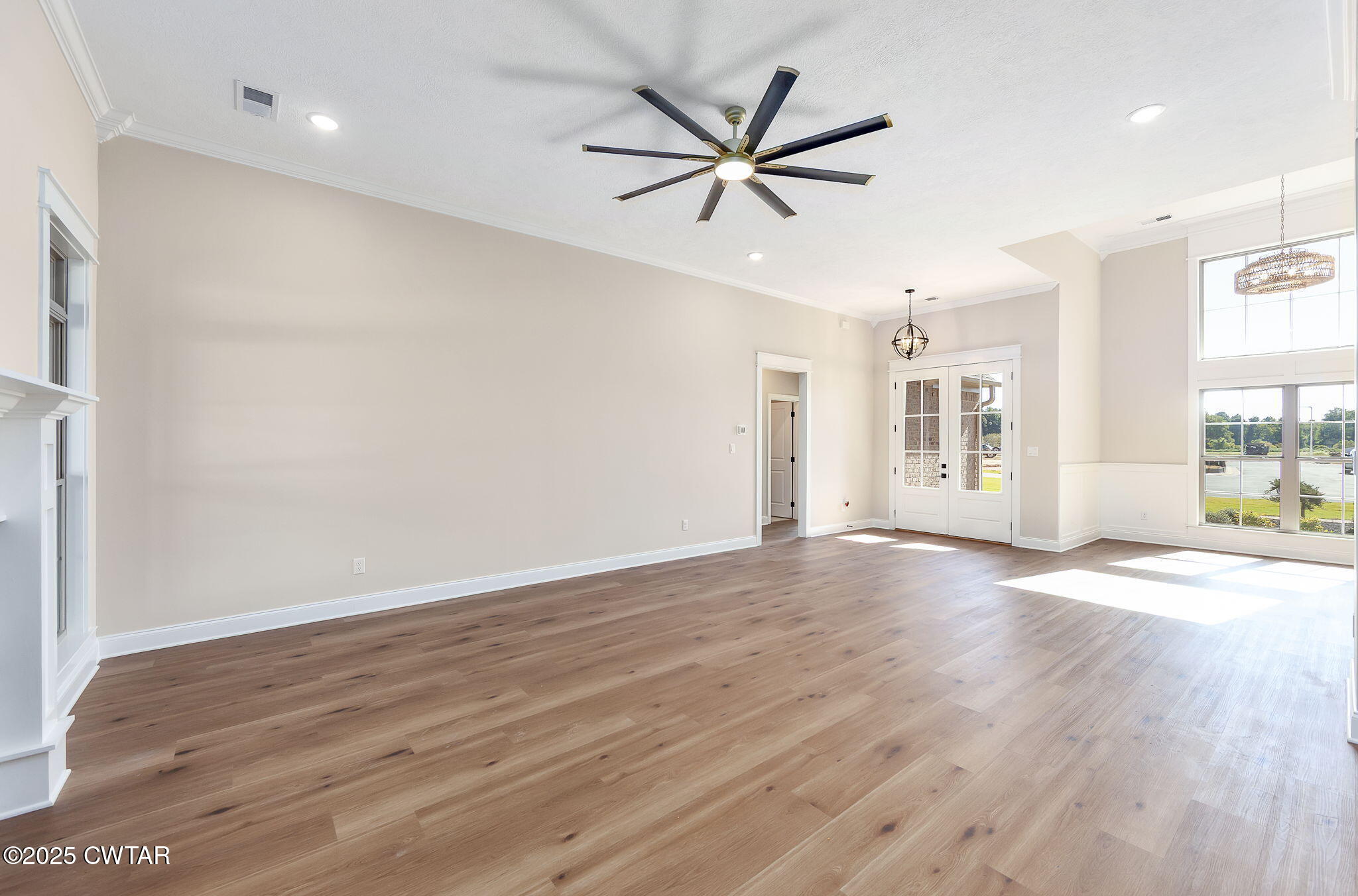 24 Enoch Cove Jackson, TN 38305 - Photo 6 of 30 a view of a livingroom with a hardwood floor and a ceiling fan