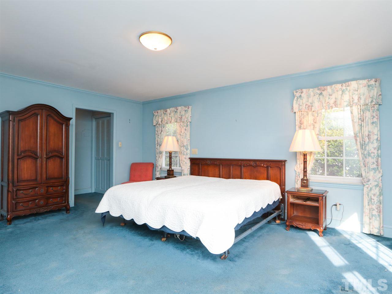2113 Coley Forest Place Raleigh, NC 27607 - Photo 14 of 25 a bedroom with a bed and a closet