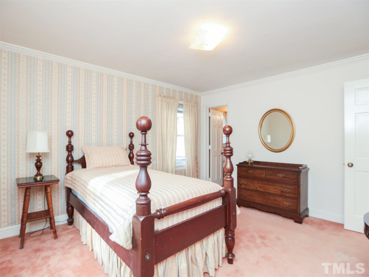2113 Coley Forest Place Raleigh, NC 27607 - Photo 22 of 25 a bed room with a bed and a window