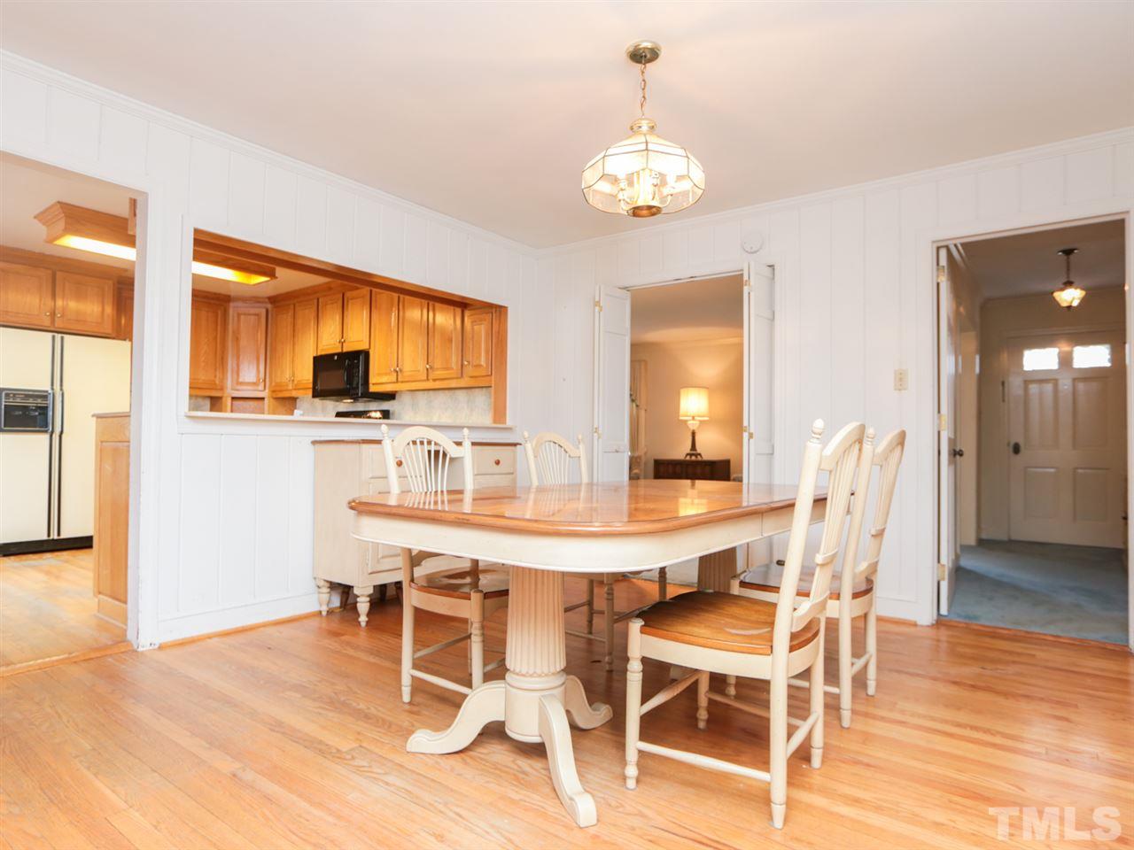 2113 Coley Forest Place Raleigh, NC 27607 - Photo 8 of 25 a view of a dining room with furniture and wooden floor