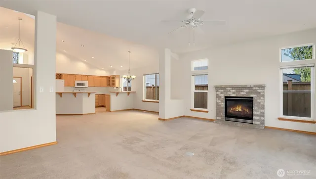 a view of a livingroom with an empty space and a fireplace