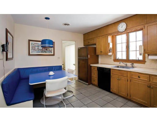 63 Lovett Road Newton, MA 02459 - Photo 5 of 5 a kitchen with stainless steel appliances kitchen island granite countertop a refrigerator a sink dishwasher a dining table and chairs with wooden floor