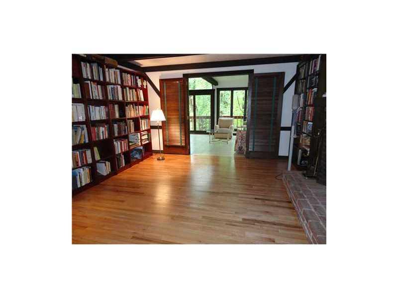 209 Highland Road Fox Chapel, PA 15238 - Photo 7 of 18 Family Room. Hardwood floors and huge built-in bookcases highlight the wooden trim features on the walls and ceiling.