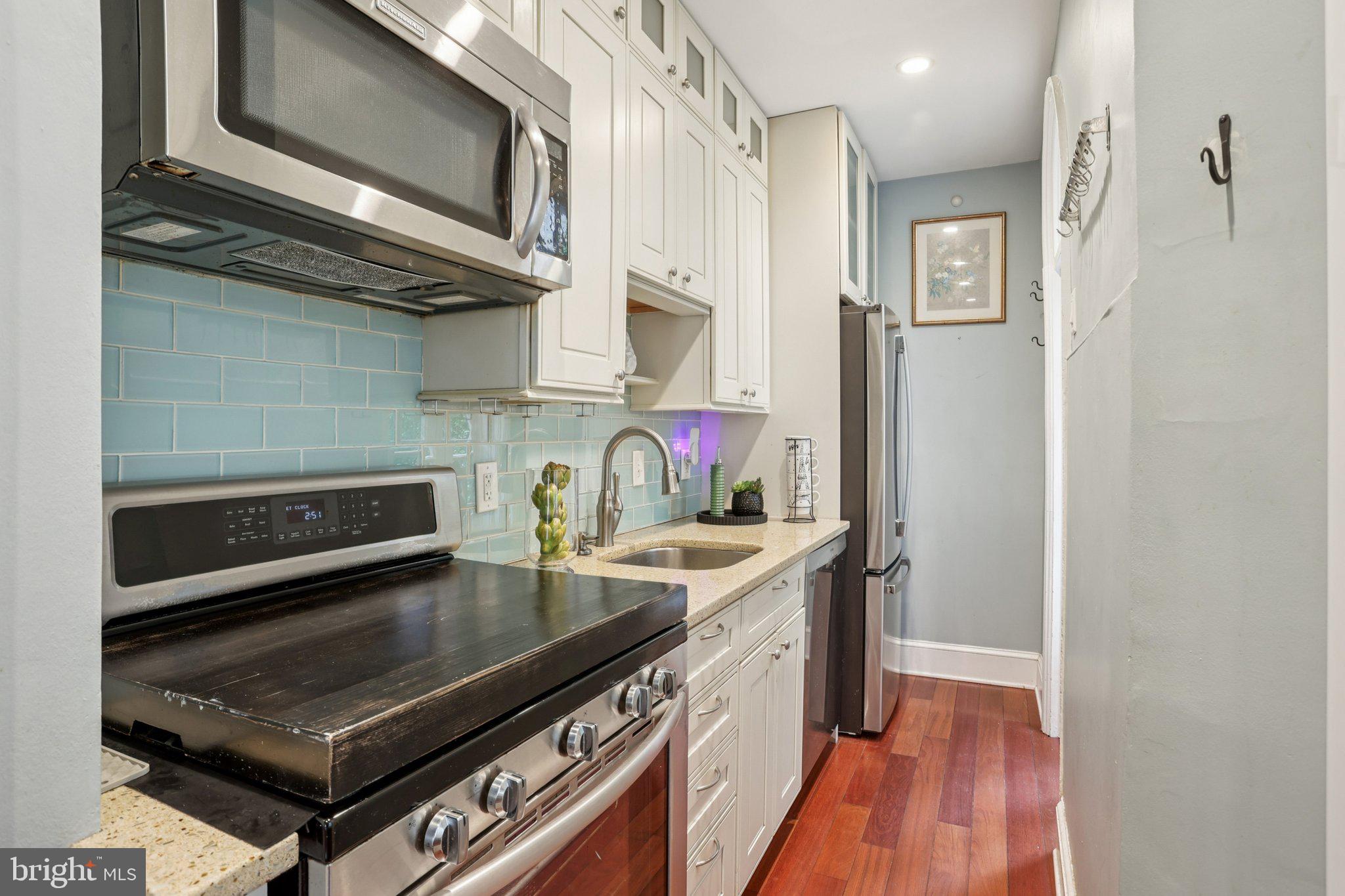323 South Camac Street Philadelphia, PA 19107 - Photo 14 of 37 a kitchen with stainless steel appliances granite countertop a stove and a sink