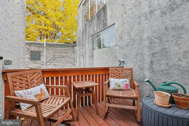 a wooden bench sitting in front of a building