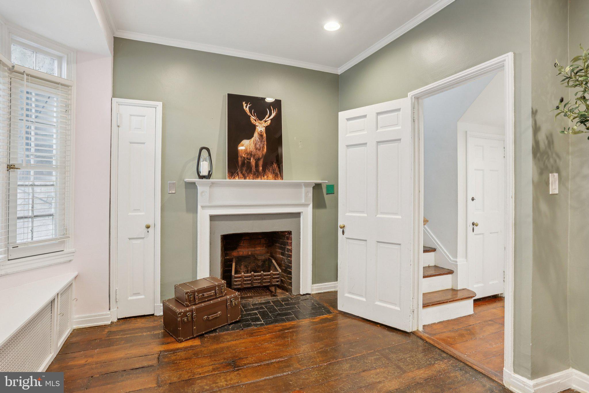 323 South Camac Street Philadelphia, PA 19107 - Photo 24 of 37 a living room with furniture and a fireplace