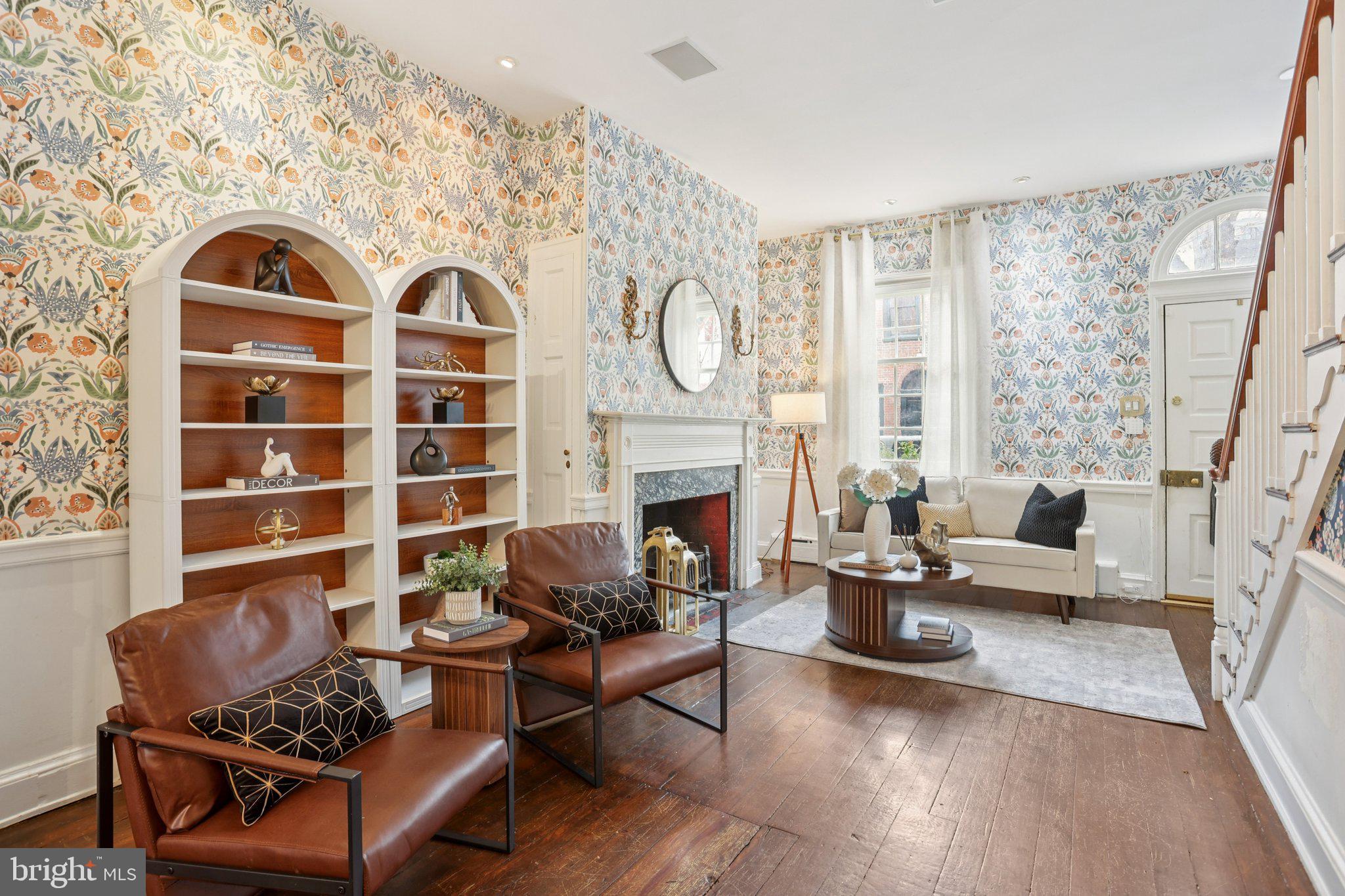 323 South Camac Street Philadelphia, PA 19107 - Photo 7 of 37 a living room with furniture a fireplace and a floor to ceiling window