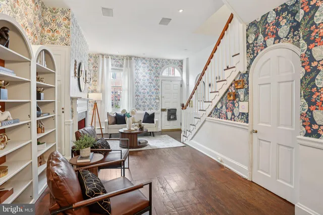 a living room with furniture and a floor to ceiling window