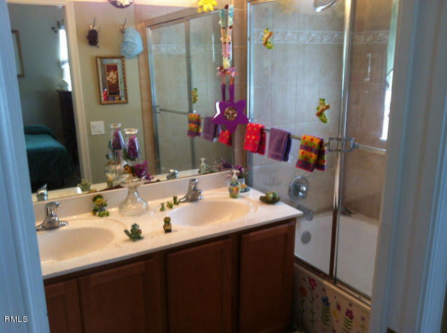 3182 Laurel Ridge Circle Riviera Beach, FL 33404 - Photo 12 of 23 a bathroom with a sink and a mirror