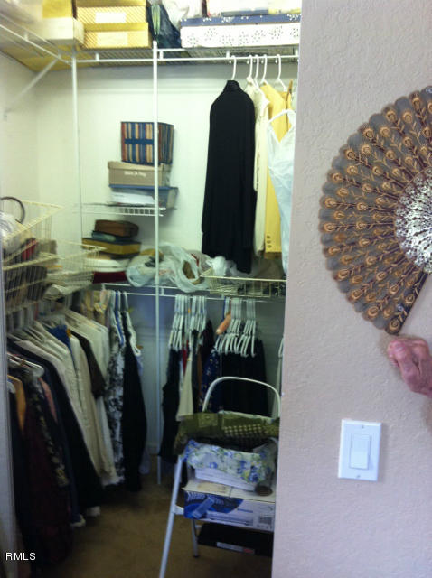 3182 Laurel Ridge Circle Riviera Beach, FL 33404 - Photo 14 of 23 a view of walk in closet with clothes and shoes