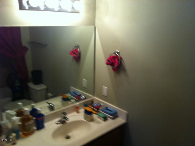 3182 Laurel Ridge Circle Riviera Beach, FL 33404 - Photo 15 of 23 a bathroom with a sink and a mirror