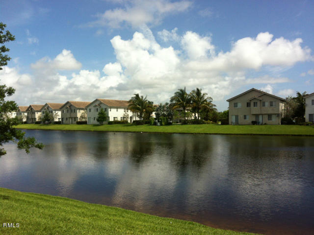 3182 Laurel Ridge Circle Riviera Beach, FL 33404 - Photo 3 of 23 a view of a lake with houses in the background