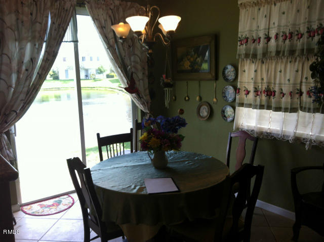 3182 Laurel Ridge Circle Riviera Beach, FL 33404 - Photo 5 of 23 a view of a dining room with furniture and wooden floor