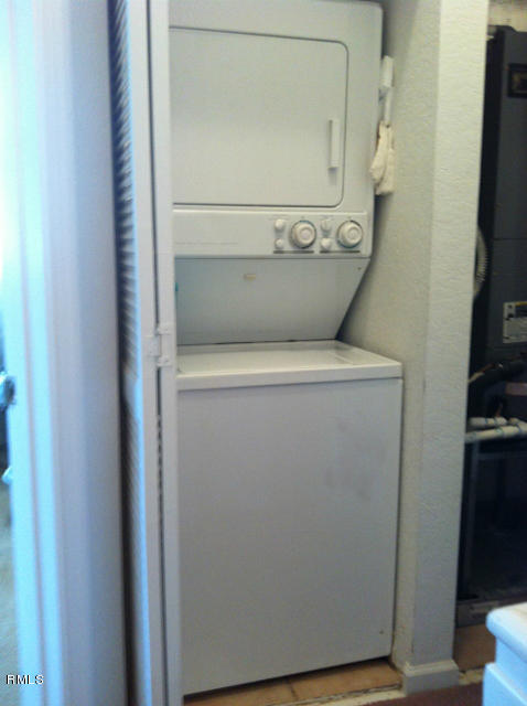 3182 Laurel Ridge Circle Riviera Beach, FL 33404 - Photo 9 of 23 a view of storage and utility room with washer and dryer
