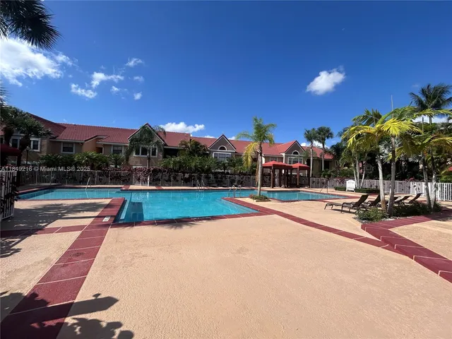 a view of swimming pool with outdoor seating and yard in back