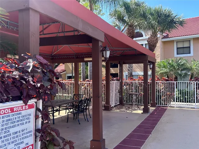 a view of a patio with table and chairs and potted plants