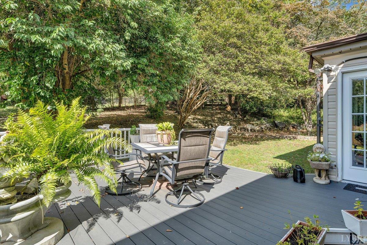 1441 Trents Ferry Road Lynchburg, VA 24503 - Photo 5 of 67 a view of a patio with table and chairs and potted plants with wooden floor and fence