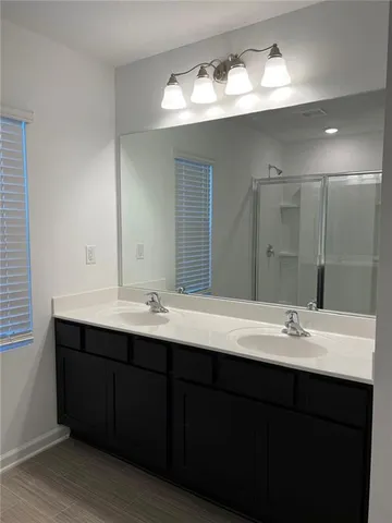 a bathroom with a sink double vanity and a mirror