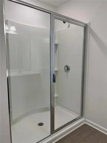 a bathroom with a glass shower door