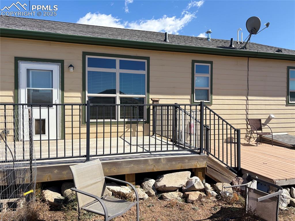 1925 Doe Valley Road Guffey, CO 80820 - Photo 4 of 31 a view of a balcony with two chairs and a wooden fence
