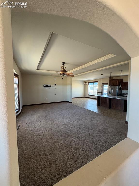 1925 Doe Valley Road Guffey, CO 80820 - Photo 6 of 31 an empty room with chandelier fan and windows
