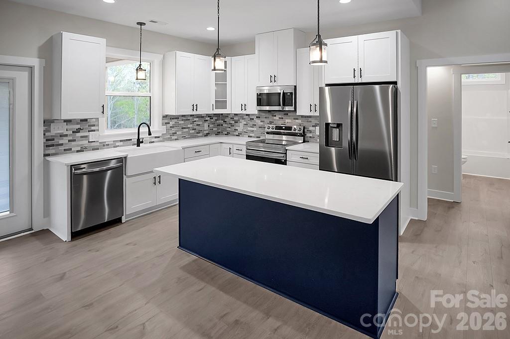 129 Rosecommon Lane Rutherfordton, NC 28139 - Photo 11 of 31 a kitchen with stainless steel appliances a sink a stove a refrigerator and island